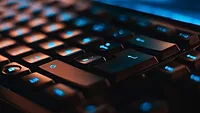 black keyboard with blue text