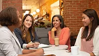 Women sitting around a conference table Women sitting around a conference table
