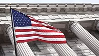 American flag in front of building columns American flag in front of building columns