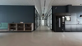 Office space with gray walls and brown chairs