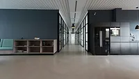 Office space with gray walls and brown chairs Office space with gray walls and brown chairs