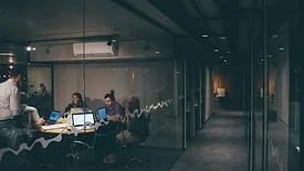 People working together in dimly lit office