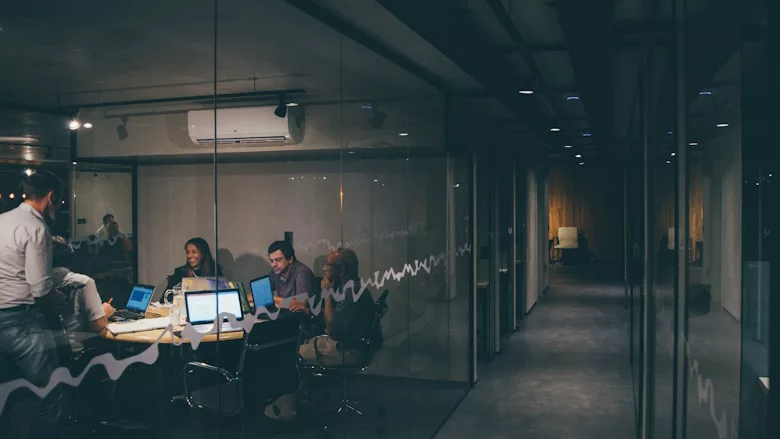 People working together in shared office space with glass doors