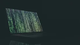 Open laptop with vertical green text
