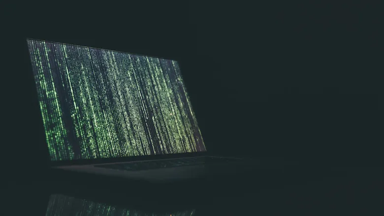 Open laptop with vertical green text
