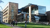 College building with large windows in front of large park