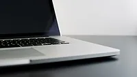 Open laptop on dark gray desk Open laptop on dark gray desk