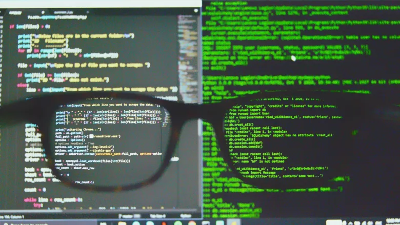Glasses in front of coding on screen
