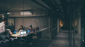 People working in conference room with glass walls