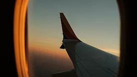 Photograph of airplane wing taken through cabin window