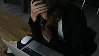 Stressed woman at laptop 