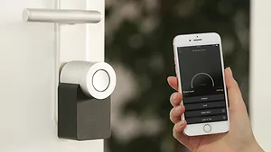 Person holding phone to smart lock