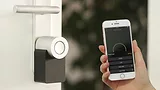 Person holding phone to smart lock