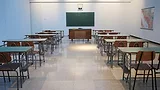 Classroom with rows of desks facing a chalkboard