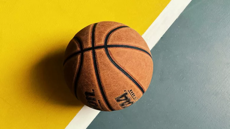 Basketball on yellow and green floor 