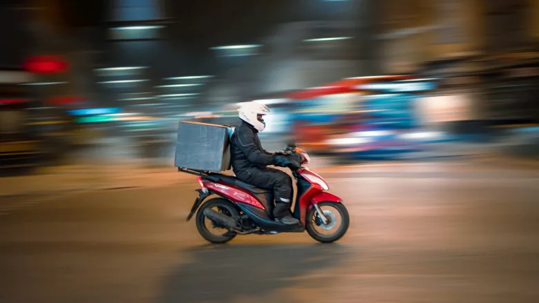 Man on motorcycle with delivery 