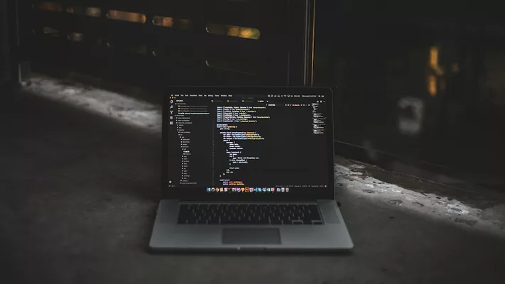 Laptop with coding on ground 