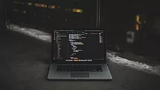 Laptop with coding on ground 