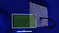 Computer with binary code hovering nearby 