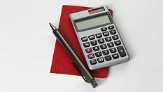 Calculator with pen and notebook