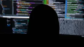 Head in front of monitors 