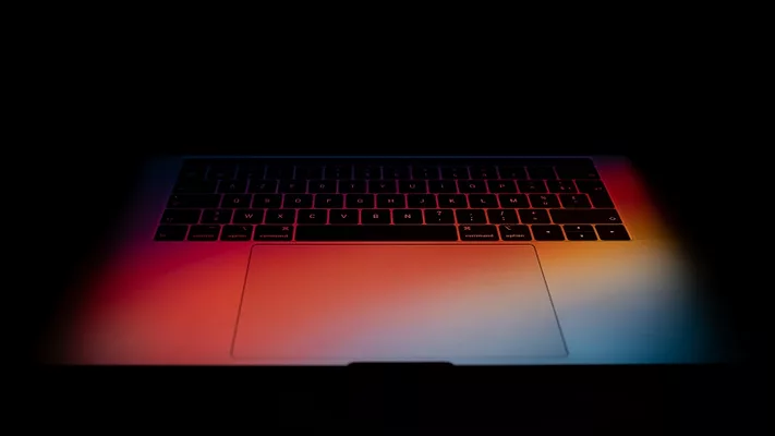 Laptop keyboard in gradient colorful light