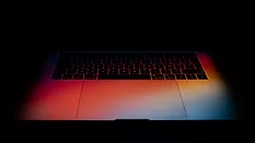 Laptop keyboard in gradient colorful light