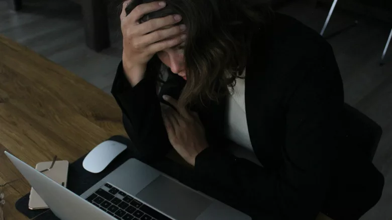 Stressed woman at laptop 