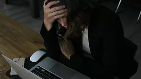 Stressed woman at laptop 