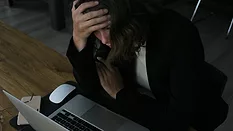 Stressed woman at laptop 