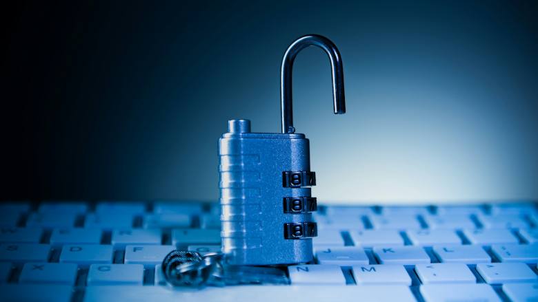 Opened padlock on computer keyboard 