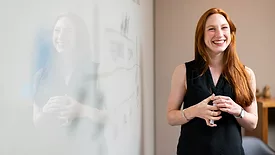 Woman by whiteboard 