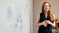 Woman by whiteboard Woman by whiteboard