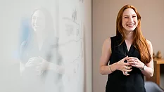 Woman by whiteboard 