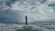 Hand reaching up out of the ocean
