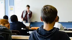 Photograph of back of students' heads in a classroom