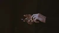 Person holding phone Person holding phone