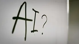 Whiteboard with "AI?" written in black marker
