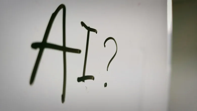 Whiteboard with "AI?" written in black marker