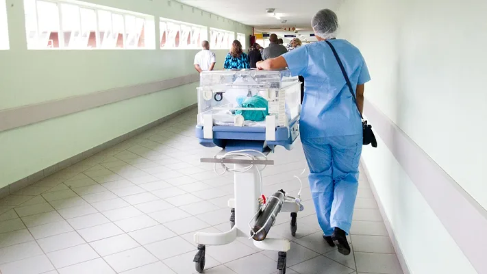 Healthcare professional with incubator 