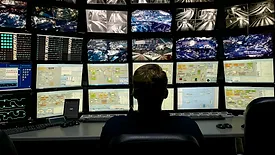 Man in front of monitors
