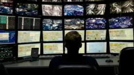 Man in front of monitors