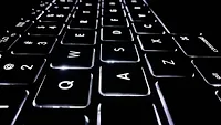 Black laptop keyboard with white lighting