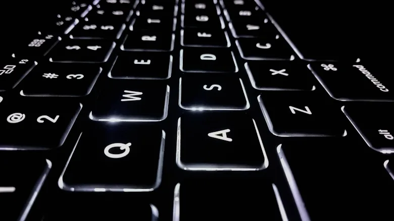 Black laptop keyboard with white lighting