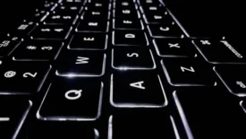 Black laptop keyboard with white lighting