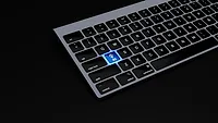 Laptop keyboard with "AI" button illuminated