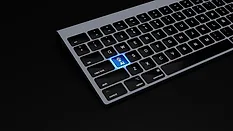 Laptop keyboard with "AI" button illuminated