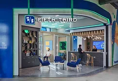 People talking at a Fifth Third bank counter