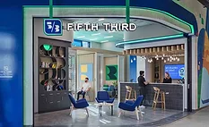 People talking at a Fifth Third bank counter