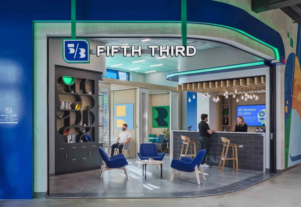 People talking at a Fifth Third bank counter